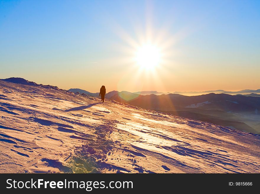 Hiker in high winter mountains