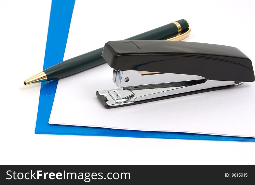 Business a still-life - black stapler, pen  and blue folder on white background. Business a still-life - black stapler, pen  and blue folder on white background