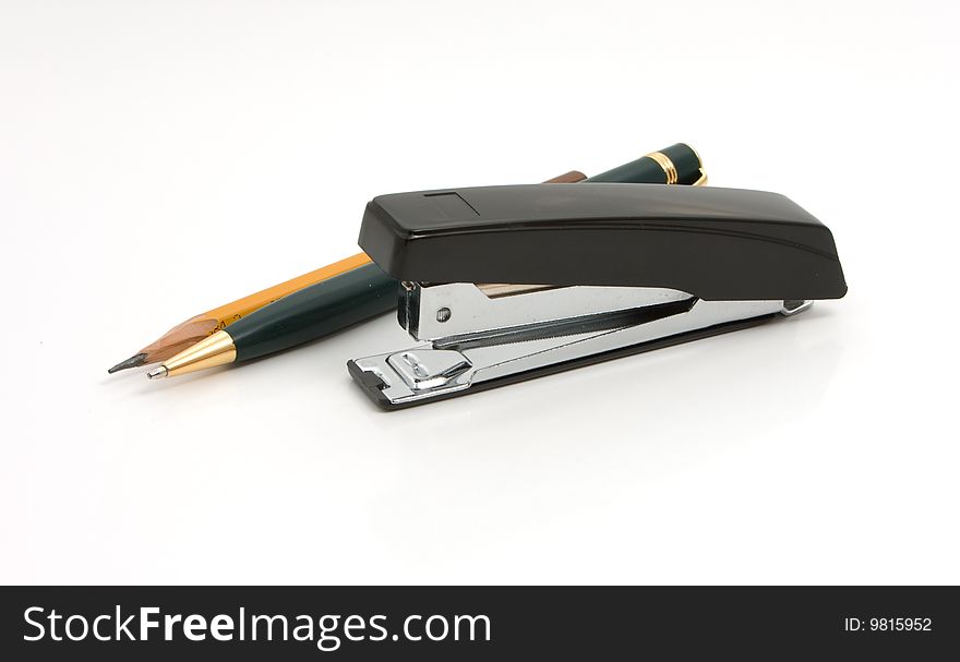 Business a still-life - black stapler and pen  on white background