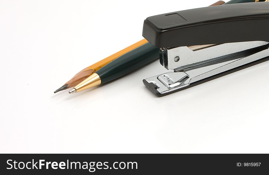 Business a still-life - black stapler and pen  on white background