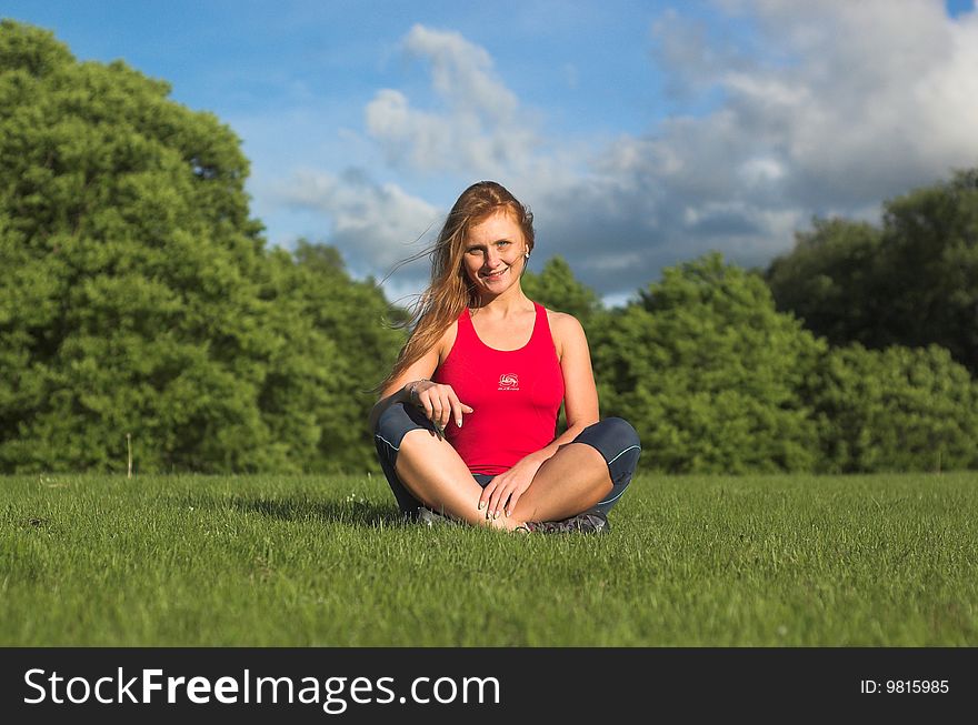 Young woman meditating in park. Young woman meditating in park