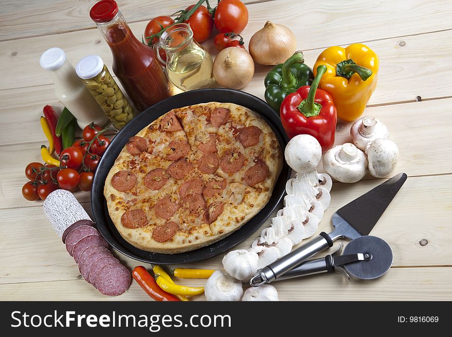 A couple of delicious pizzas, with raw tomatoes, green peppers and salami. A couple of delicious pizzas, with raw tomatoes, green peppers and salami