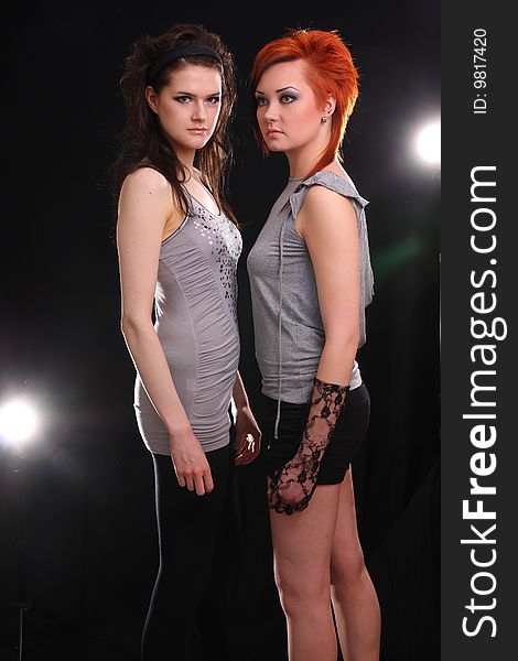 Two young models posing in the studio with backlights. Two young models posing in the studio with backlights