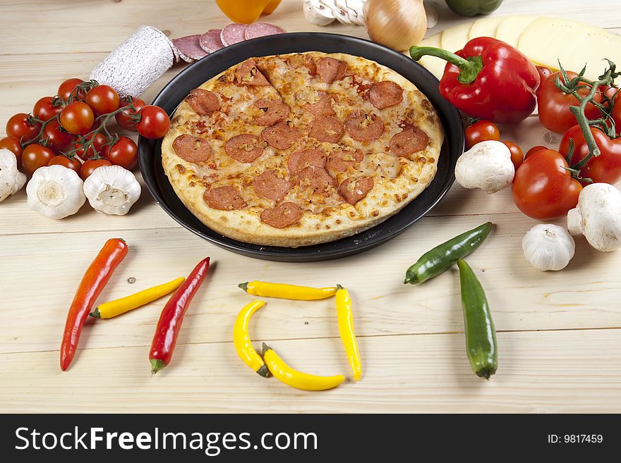 A couple of delicious pizzas, with raw tomatoes, green peppers and salami. A couple of delicious pizzas, with raw tomatoes, green peppers and salami