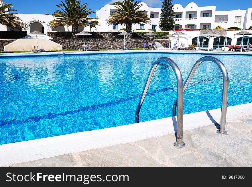 Beautiful blue swimming pool and handrails