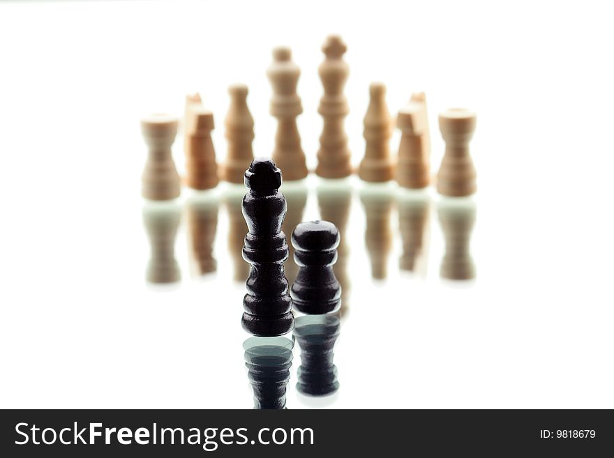 Black Chess King and single pawn against white chess army on white background. Black Chess King and single pawn against white chess army on white background