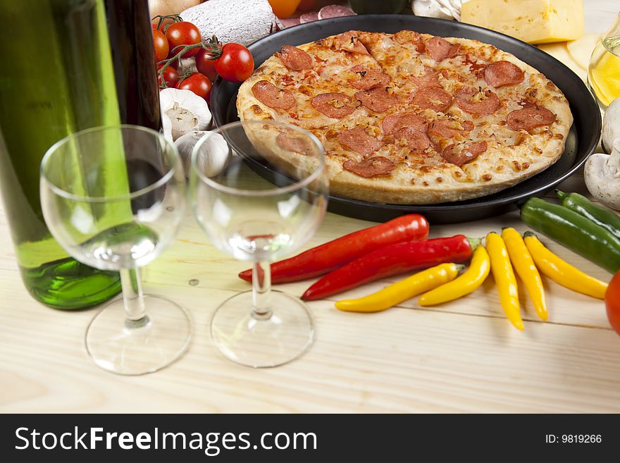 A couple of delicious pizzas, with raw tomatoes, green peppers and salami. A couple of delicious pizzas, with raw tomatoes, green peppers and salami