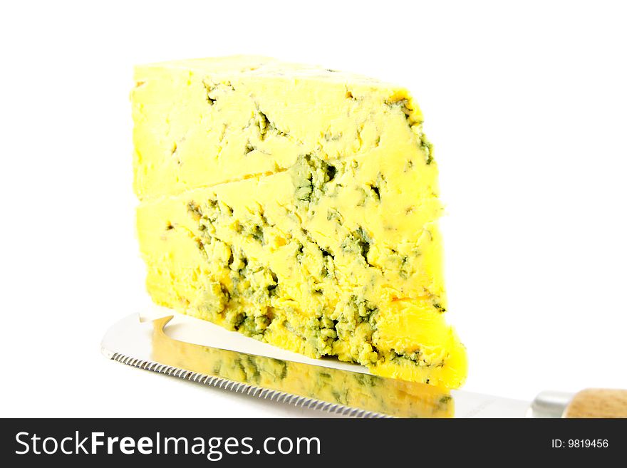 Slice of blue cheese and knife with clipping path on a white background. Slice of blue cheese and knife with clipping path on a white background