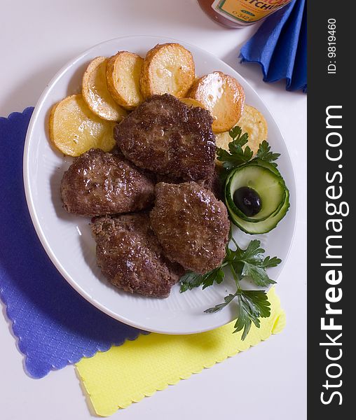 Aromatic chops with baked potatoes and green. Aromatic chops with baked potatoes and green