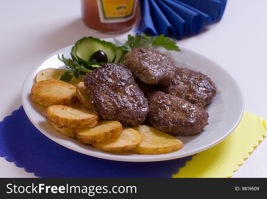 Aromatic chops with baked potatoes and green. Aromatic chops with baked potatoes and green