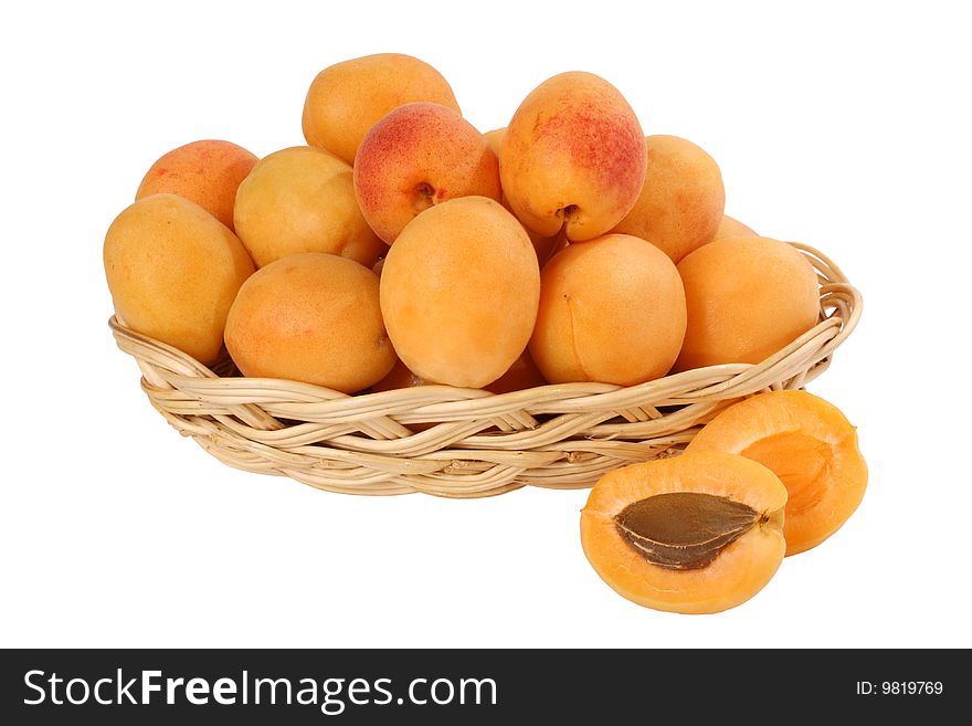 Ripe apricots in a basket on a white background it is isolated. Ripe apricots in a basket on a white background it is isolated