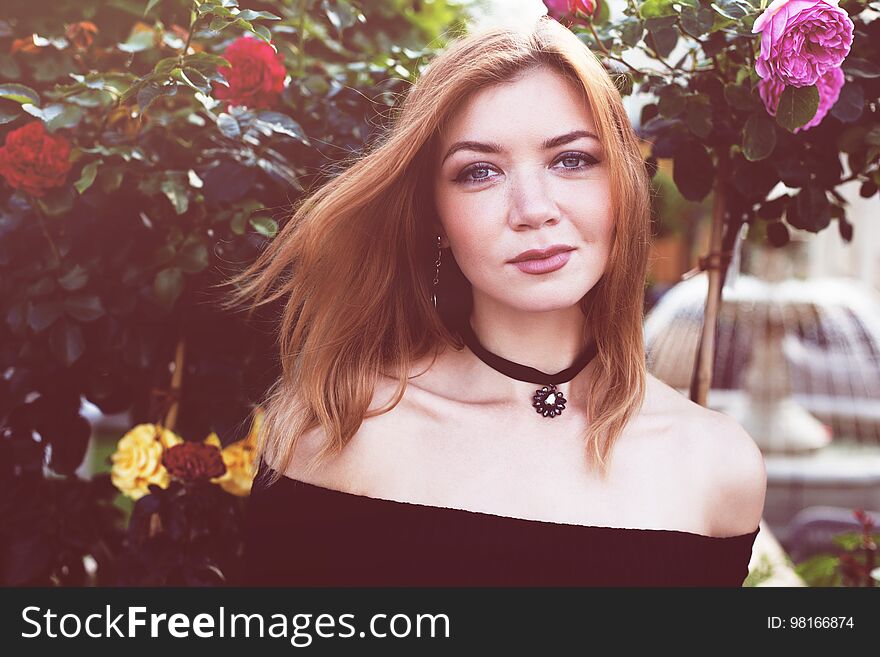 Girl with red hair in a black dress