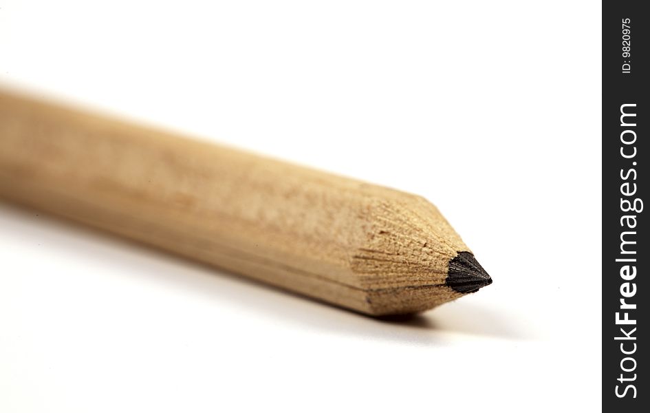 Wooden pencil close-up, isolated on a white background