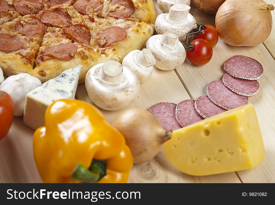 A couple of delicious pizzas, with raw tomatoes, green peppers and salami. A couple of delicious pizzas, with raw tomatoes, green peppers and salami