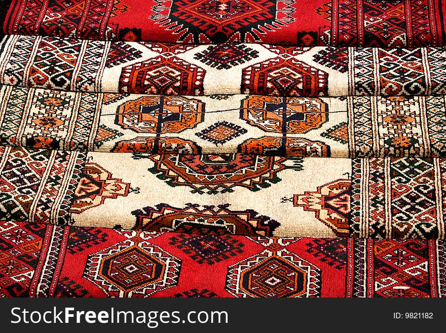 Few handmade carpets with traditional ornament. Turkmenistan. Ashkhabad market.