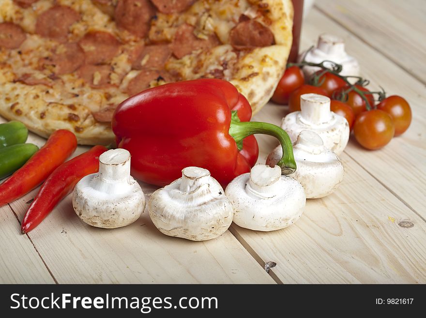 A couple of delicious pizzas, with raw tomatoes, green peppers and salami. A couple of delicious pizzas, with raw tomatoes, green peppers and salami