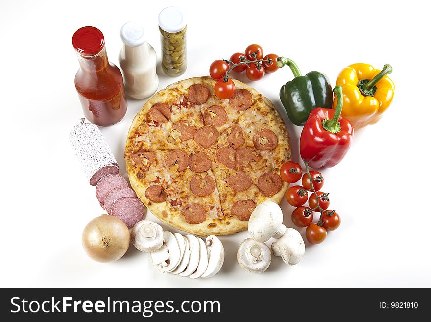 A couple of delicious pizzas, with raw tomatoes, green peppers and salami. A couple of delicious pizzas, with raw tomatoes, green peppers and salami