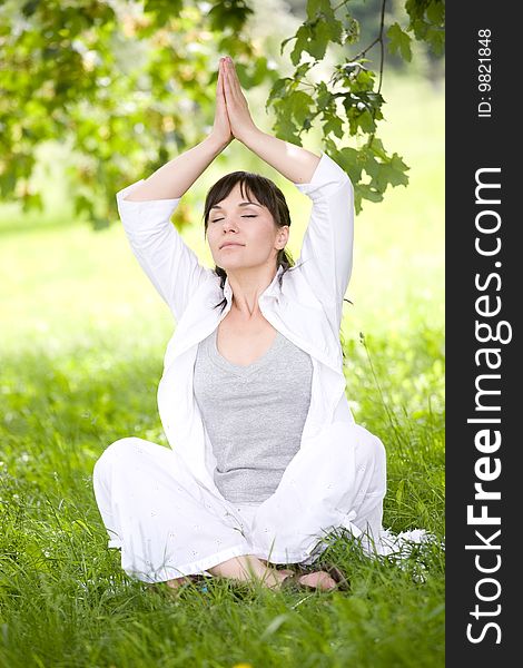 Attractive brunette woman relaxing on grass. Attractive brunette woman relaxing on grass