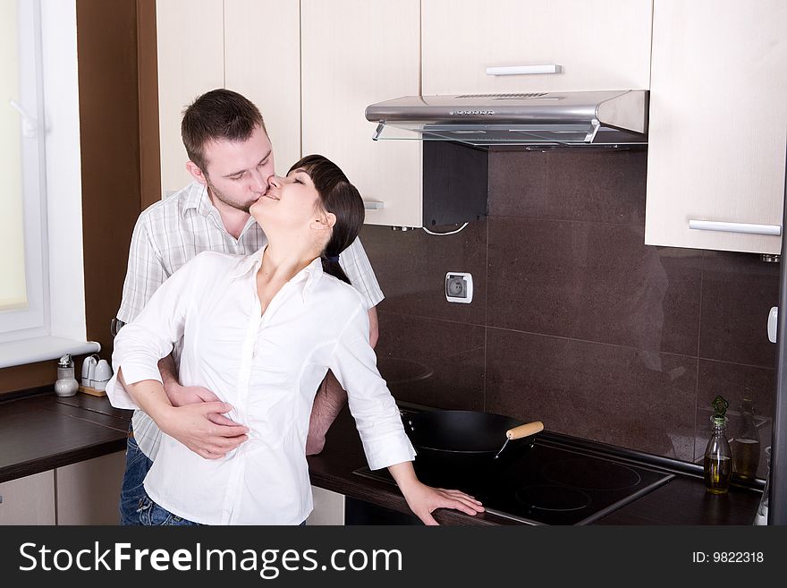 Young couple together in kitchen. Young couple together in kitchen