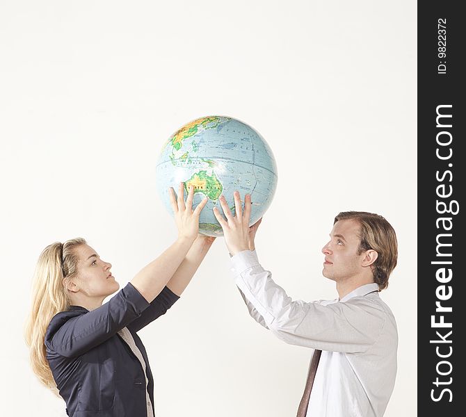 Male and female professional holding globe. Male and female professional holding globe