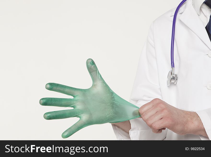 Medical professional pulling on glove. Medical professional pulling on glove