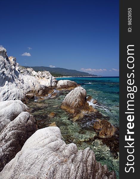 Seashore with rocks and beautiful clear blue water