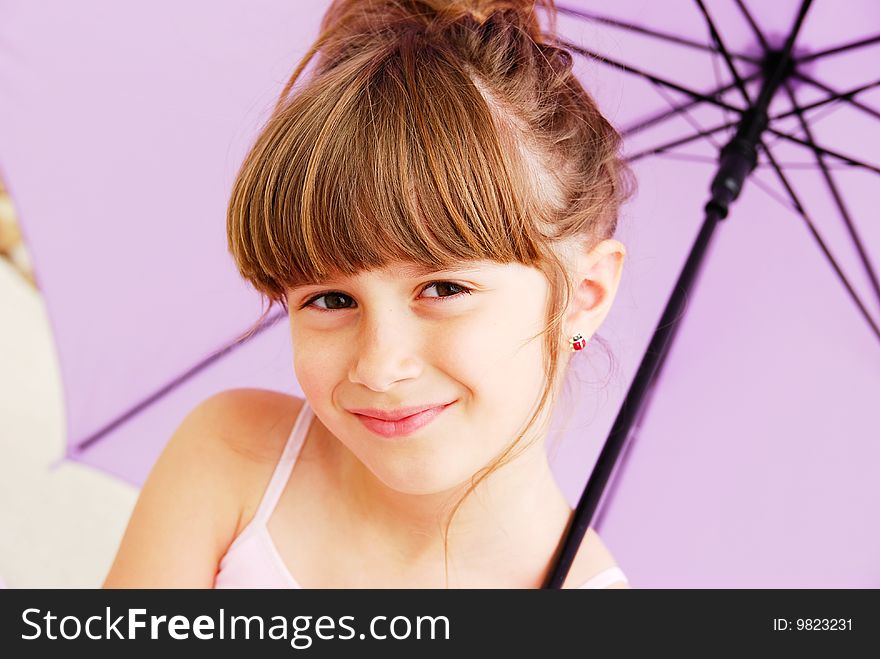 A beautiful young girl holding an umbrella. A beautiful young girl holding an umbrella