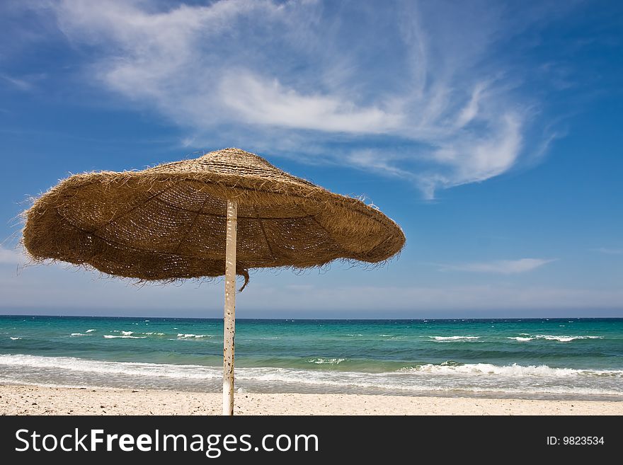 One sunshade on beach in Tunisia