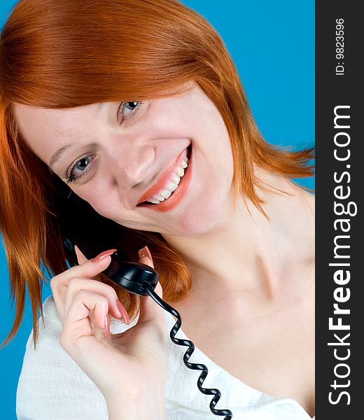 Closeup portrait of beautiful red girl with phone