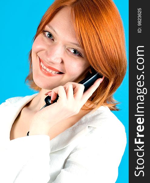 Closeup portrait of beautiful red girl with phone