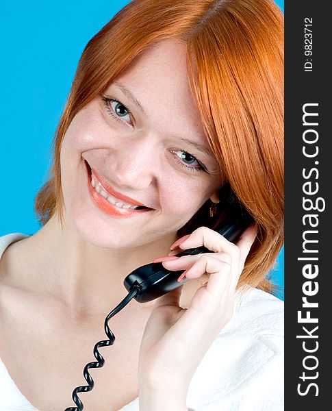 Closeup portrait of beautiful red girl with phone