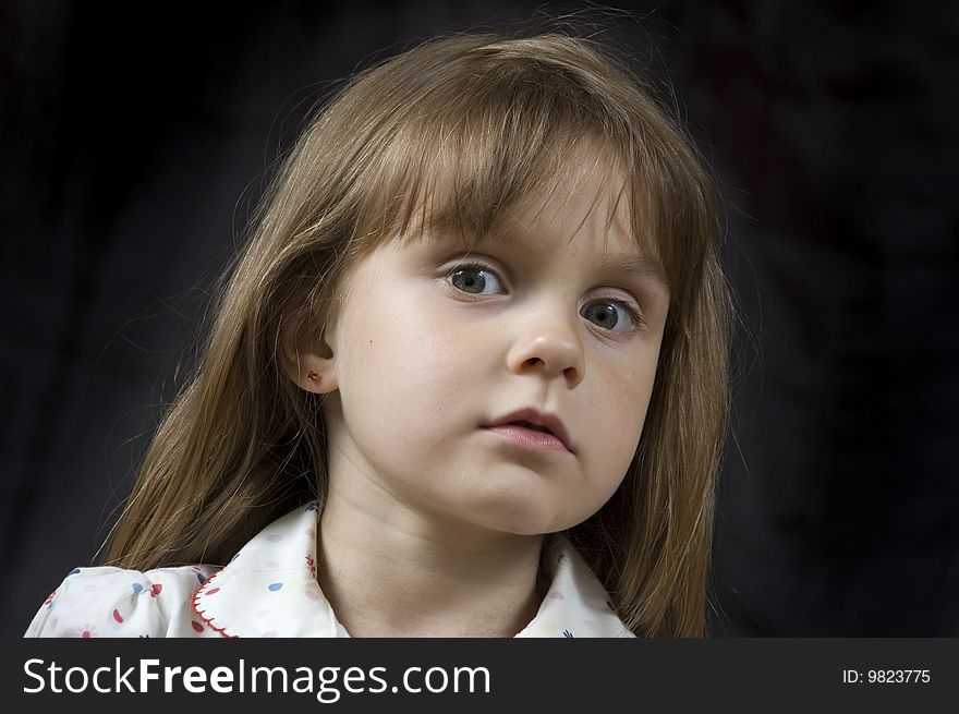 Adorable little pensive girl' portrait against black. Adorable little pensive girl' portrait against black