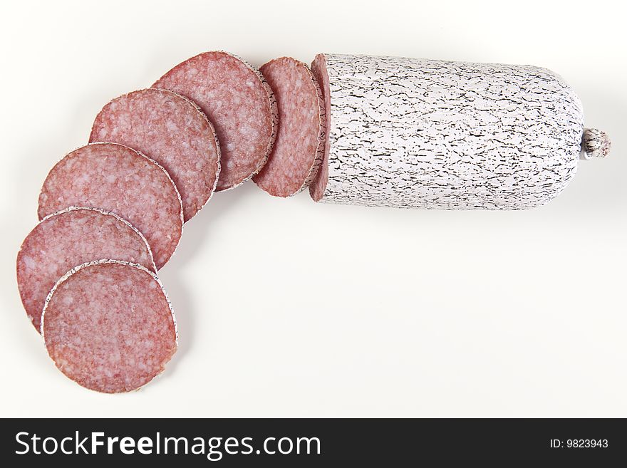 Macro picture of slice of salami isolated on white background