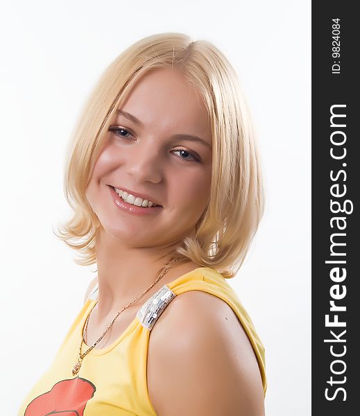 Portrait of blond smiling girl in yellow , on white background. Portrait of blond smiling girl in yellow , on white background