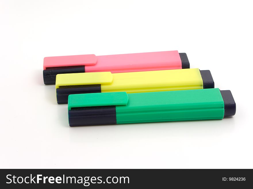 Three markers - red, yellow, greed on white background. School and preschool education. Office tools.
