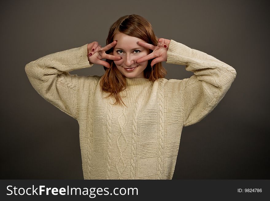 Smiling red haired girl in sweater isolated