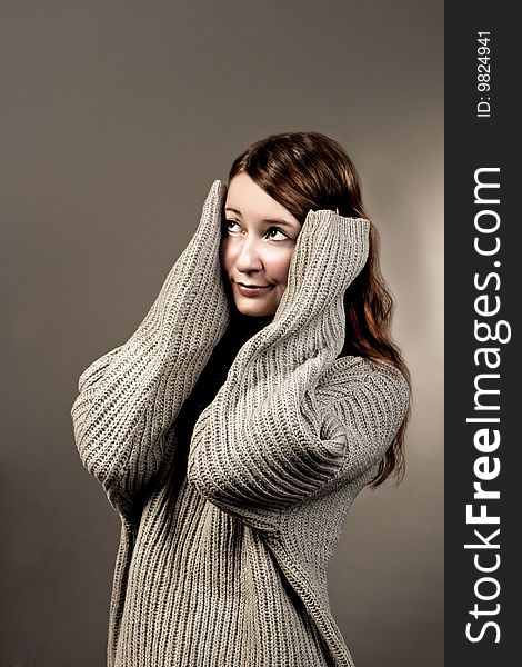 Impressed red haired girl in grey sweater isolated