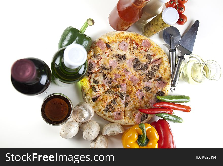 A couple of delicious pizzas, with raw tomatoes, green peppers and mushrooms. A couple of delicious pizzas, with raw tomatoes, green peppers and mushrooms