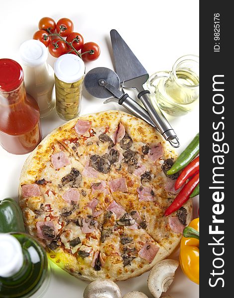 A couple of delicious pizzas, with raw tomatoes, green peppers and mushrooms. A couple of delicious pizzas, with raw tomatoes, green peppers and mushrooms