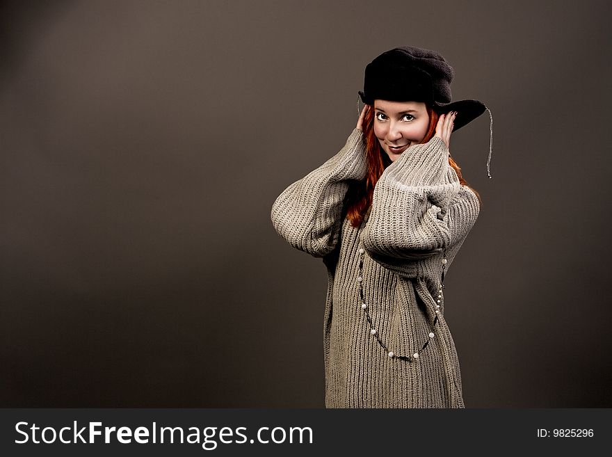 Woman in winter hat smiling towards to camera isolated