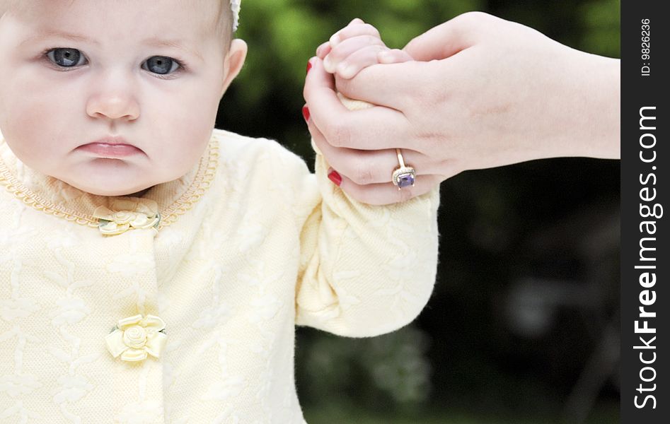 Baby girl holding mother's hand. Baby girl holding mother's hand