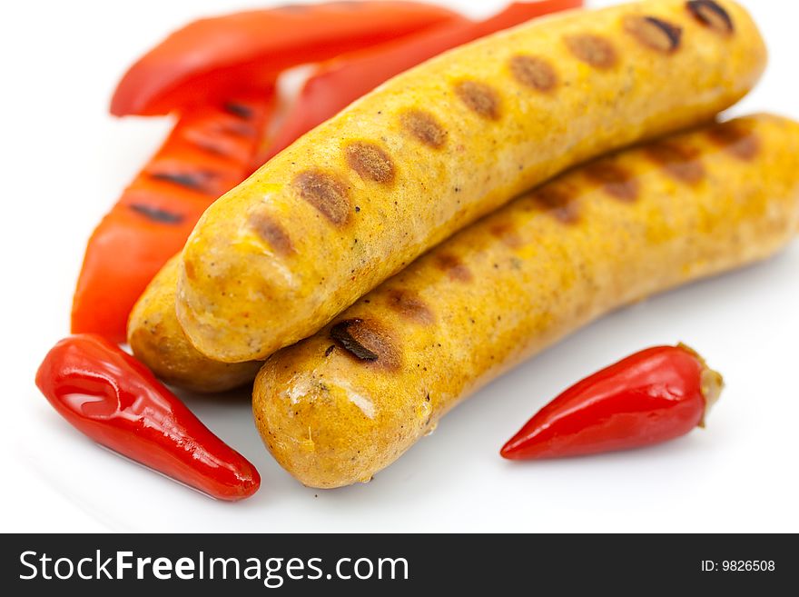 Fresh grilled sausages with red bell pepper.