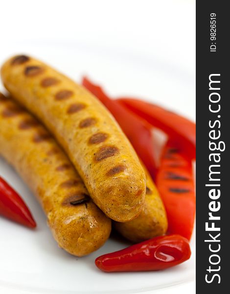 Fresh grilled sausages with red bell pepper.