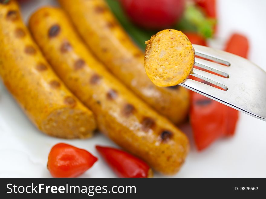 Fresh grilled sausages with red bell pepper