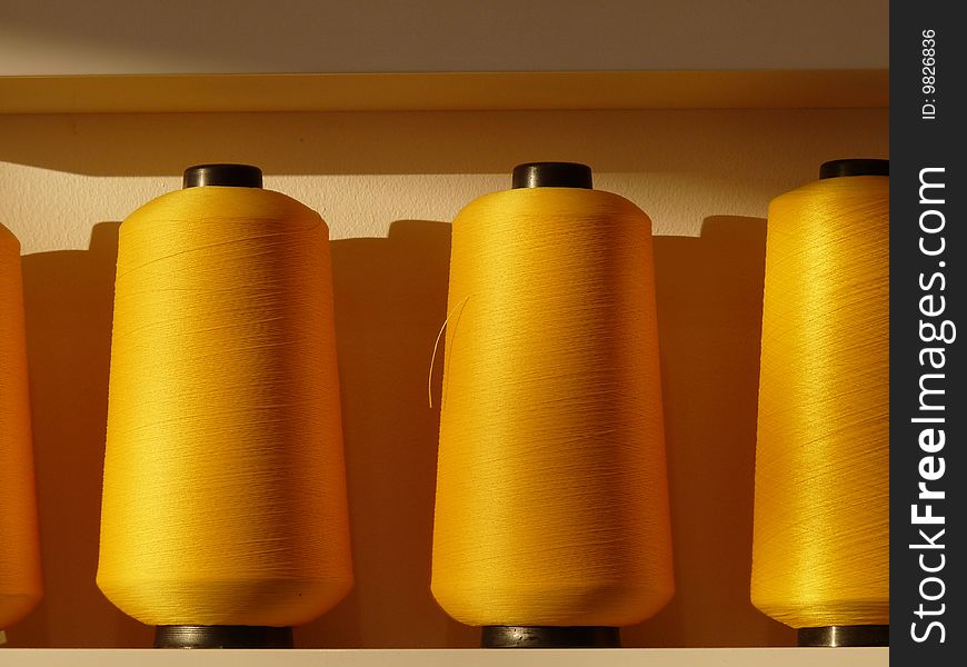 Yellow bobbins on the shelf