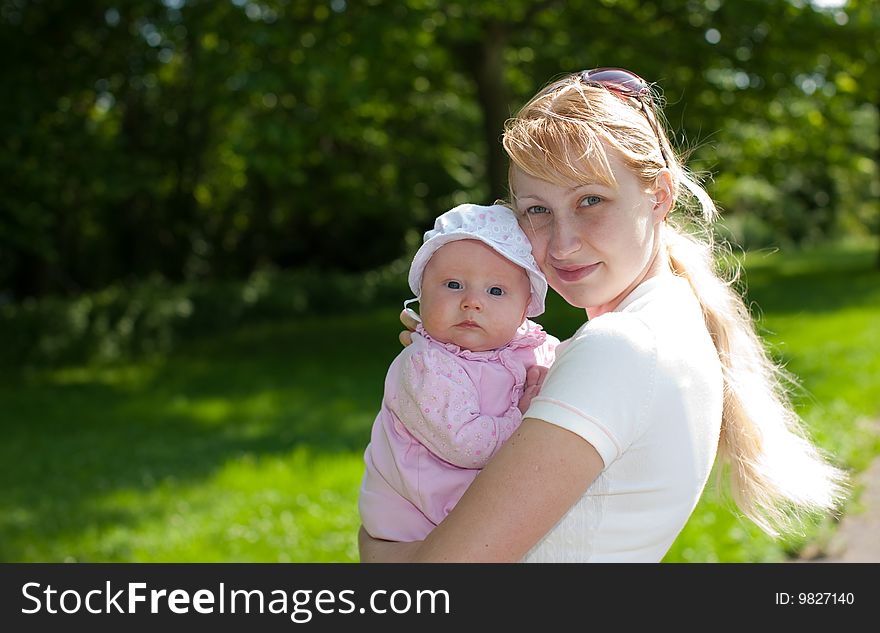 Loving mother and 2 month old baby outdoors. Loving mother and 2 month old baby outdoors