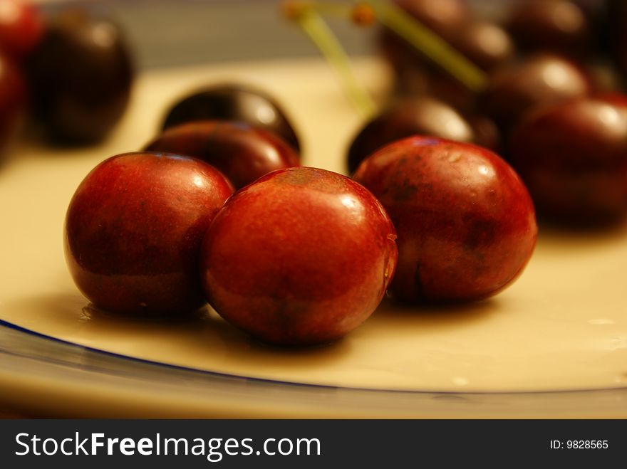 Several red cherry on a dish