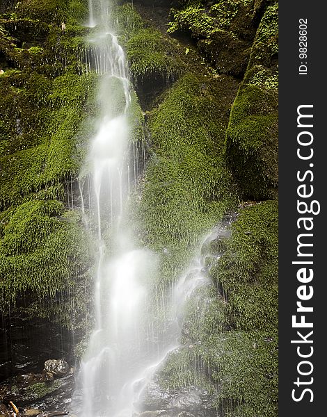 Waterfall with mossy green rocks. Waterfall with mossy green rocks