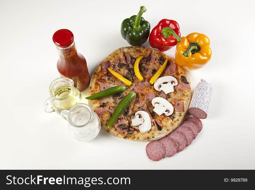 A couple of delicious pizzas, with raw tomatoes, green peppers and mushrooms. A couple of delicious pizzas, with raw tomatoes, green peppers and mushrooms