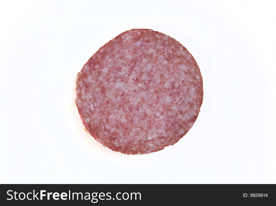 Macro picture of slice of salami isolated on white background